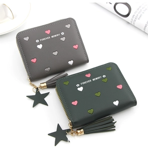 Detail of short wallets with heart embroidery, fringe tassels and star charm pendants