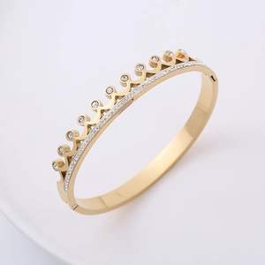Golden crown wave bangle with pavé crystal accents shown from a elegant side perspective