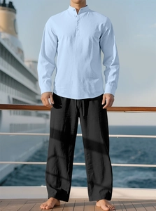 Men's light blue cotton linen shirt and black pants set on a cruise ship deck