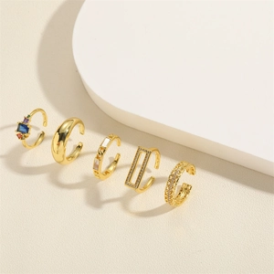 Set of five gold adjustable rings with hollow heart mesh and cubic zirconia designs