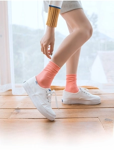 Pink velvet mid-calf socks showing fine vertical ribbed texture worn with canvas shoes