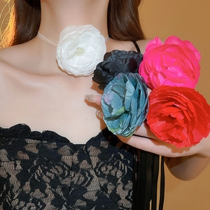 Close-up of a large lace fabric flower choker necklace on a female model neck