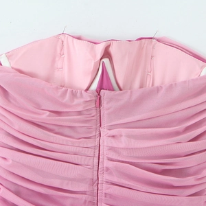 Dettaglio posteriore dell'abito aderente in mesh rosa con arricciature e zip nascosta