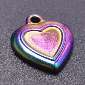 Macro shot of a heart-shaped rainbow plated stainless steel pendant for DIY jewelry