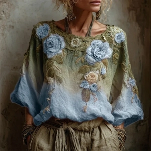 Close-up of 3D floral embroidery on bohemian teal gradient lantern sleeve dress