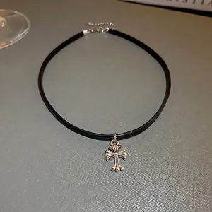 Gothic black faux leather choker necklace featuring a vintage silver cross pendant charm
