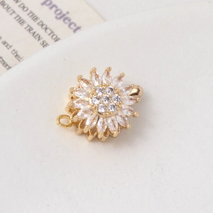 Macro shot of gold-plated rotating sunflower clasp with sparkling zircon paving