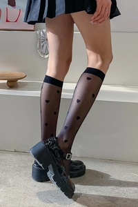 Detail view of sheer black knee-high JK socks with heart pattern and wide cuffs