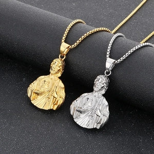 Close-up of gold and silver Saint Jude pendants on stainless steel box chains