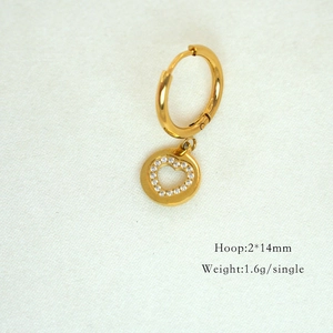 Detailed macro view of 14K gold-plated hoop earring with sparkling zircon heart charm