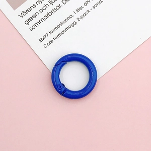 Close-up of a 20mm bright blue painted spring gate ring O-ring for DIY jewelry making