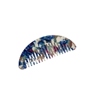 Portable acetate hair comb with blue and white marble pattern in a half-moon shape