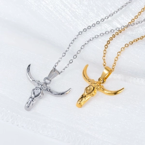 Macro detail of silver and gold plated longhorn bull skull pendants with intricate textures
