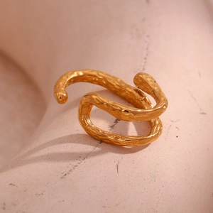 Detail of 18K gold plated stainless steel ring with organic hammered texture finish