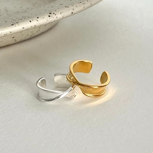 Detail of minimalist S925 sterling silver folded rings in gold and silver finishes