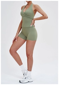 Detailed side view of high-stretch olive green halter sports top and high-waisted shorts