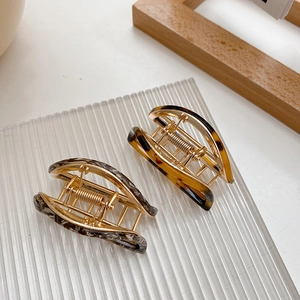 Elegant gold metal hair claw clips with marble and tortoiseshell acetate patterns