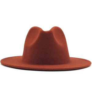 Close-up of a caramel brown wool felt fedora featuring a classic flat brim and pinched crown
