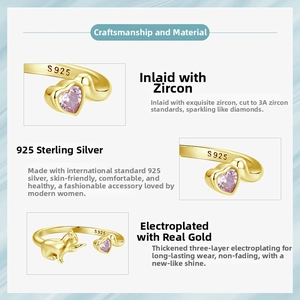 Macro shot of S925 silver ring featuring a pink heart zircon and golden cat detail