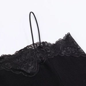 Detailed close-up of black ribbed knit top featuring delicate lace trim and stitching