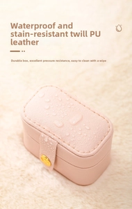 Detail of pink PU leather jewelry box showing waterproof surface and gold button