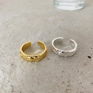 Detailed shot of irregular 925 sterling silver rings showing S925 hallmark and lava texture