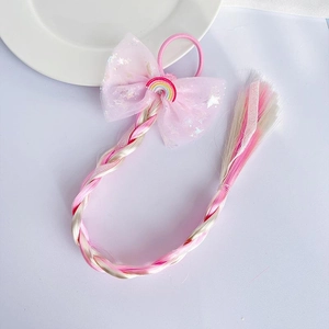 Pink bow hair tie with rainbow extensions and a colorful unicorn star charm detail