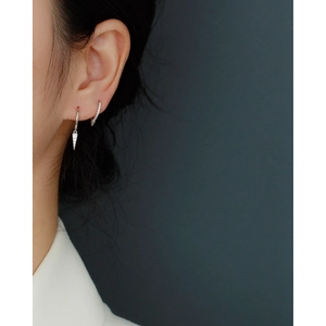 Detail of silver S925 sterling silver geometric stud earring with sparkling diamond pavé