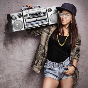 Retro boombox carried on shoulder by a model wearing hip hop cosplay accessories
