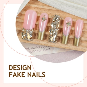 Pink and gold long press-on nails with luxury French tips, diamonds and star charms