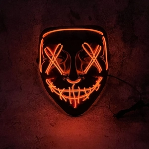 Halloween scary LED mask with orange neon glow wires in a dark horror atmosphere