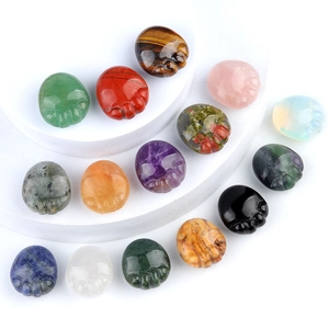 Multiple natural crystal agate stone cat paw carvings displayed on a white podium