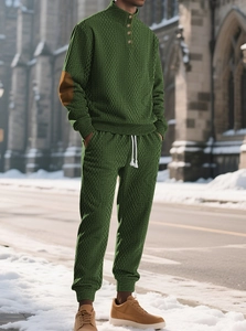 Close-up of men's dark green tracksuit with geometric knit texture and elbow patches