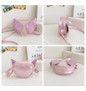 Detailed view of pink glitter girl's crossbody bag with angel wings and sequins