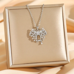 Elegant silver butterfly necklace with micro-pave cubic zirconia on silk background