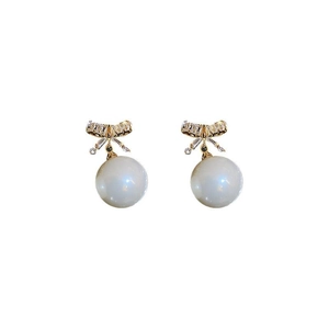 Vintage gold bow earrings with sparkling zircons and elegant white pearls on white background