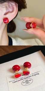 Detail of square red crystal and round bead earrings with gold plated 18K finish