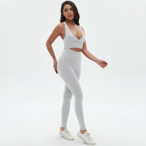 Detail of grey seamless yoga set showing cross neckline sports bra and high waist leggings