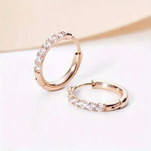Sparkling rose gold huggie hoop earrings with round-cut cubic zirconia in a minimalist style