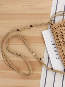 Handmade woven straw shoulder bag with wooden bead straps for bohemian summer beach vacations