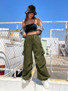 Close-up of military green cargo pants with multiple pockets and drawstring waist detail