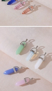 Detailed view of various hexagonal crystal pendants in pink blue and green stone colors