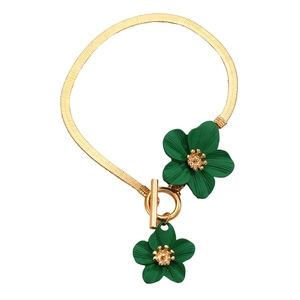 Flat gold snake chain bracelet featuring green enamel flowers with a T-bar toggle clasp