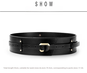 Detail view of black multi-layered wide waist belt featuring gold square metal buckles