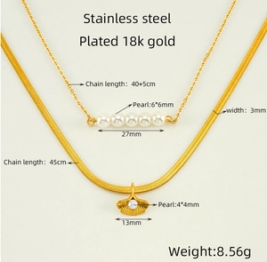 Detail of 18K gold plated stainless steel layered necklace with ginkgo leaf and pearls