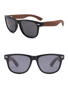 Detail view of retro oval sunglasses with walnut wood arms and silver rivet accents