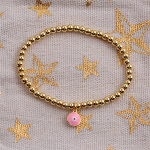 Detailed top view of gold-plated beaded bracelet with pink enamel evil eye charm