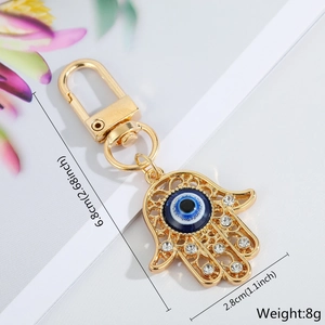 Detailed view of Hand of Fatima keychain with blue evil eye and dimensions 6.8x2.8cm