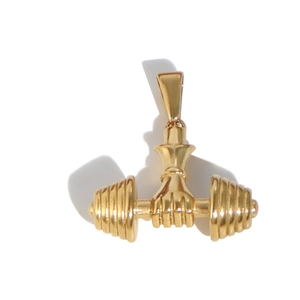 Close-up of polished gold hand clutching a dumbbell pendant for fitness jewelry