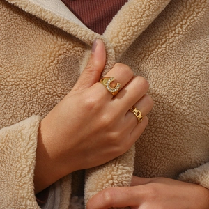 Luxury 18K gold plated U-shaped horseshoe ring with cubic zirconia on a model hand